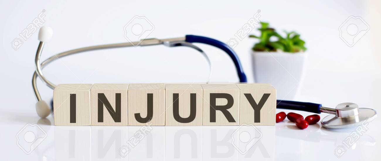 154035243 injury the word is written on wooden cubes and sthetoscope and piils medical concept